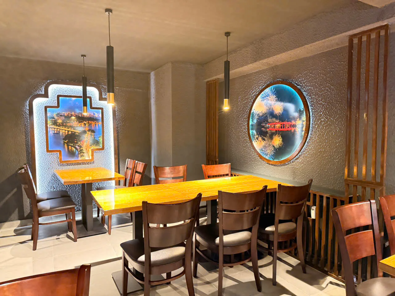 Dining area with warm wood details and illuminated artwork